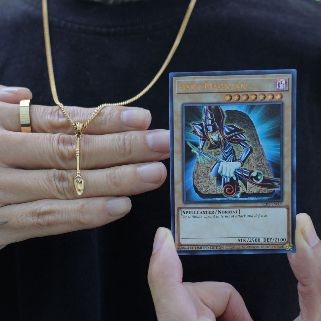 dark magician staff from yugioh next to a yugioh dark magician card