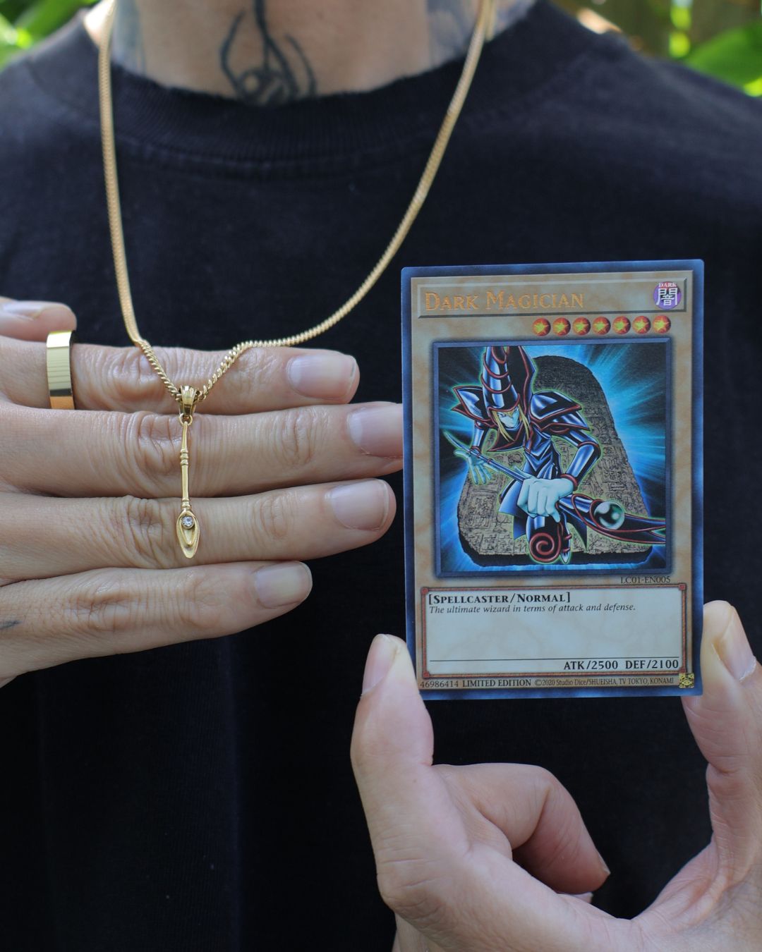 dark magician staff from yugioh next to a yugioh dark magician card