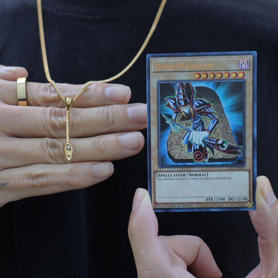 dark magician staff from yugioh next to a yugioh dark magician card